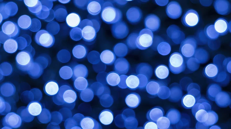 Blurred blue lights forming a circular bokeh pattern against a dark background