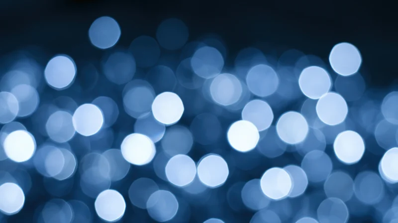 Blurred blue lights creating a soft bokeh effect against a dark background