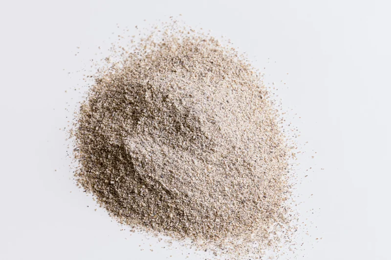 Pile of psyllium husk powder on white background
