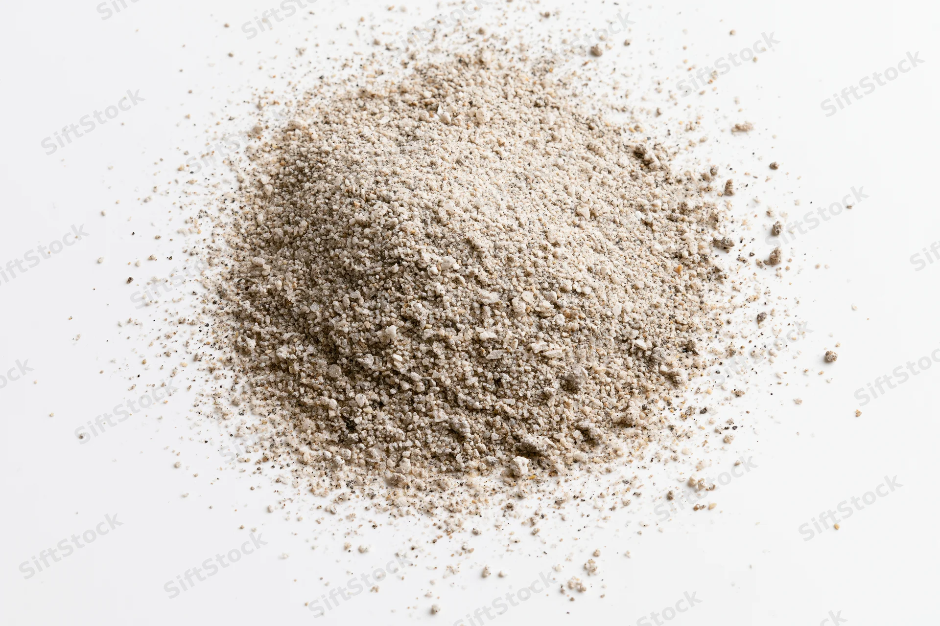 Pile of beige granular powder on white background