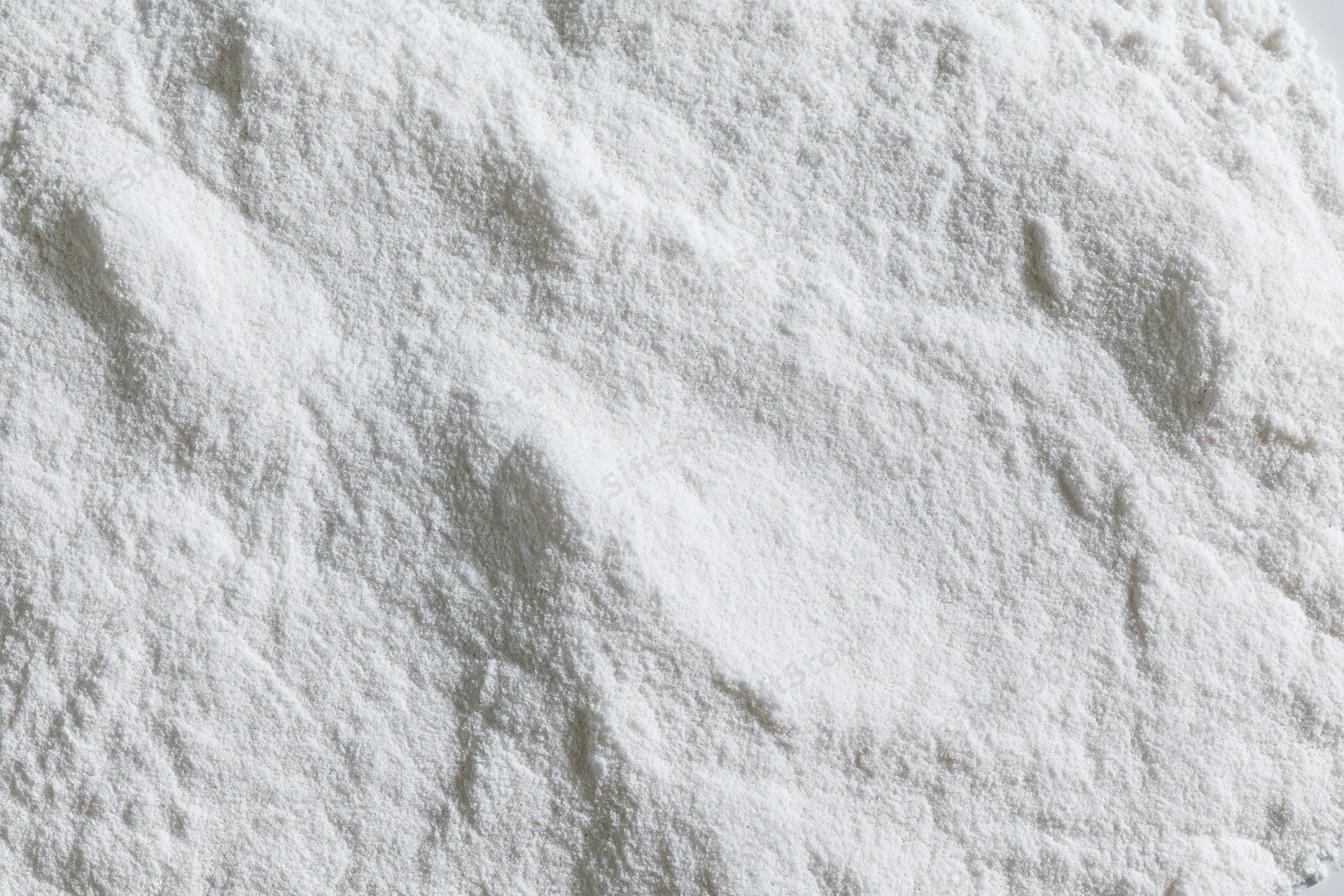 Closeup of white powder pile showing fine granular texture