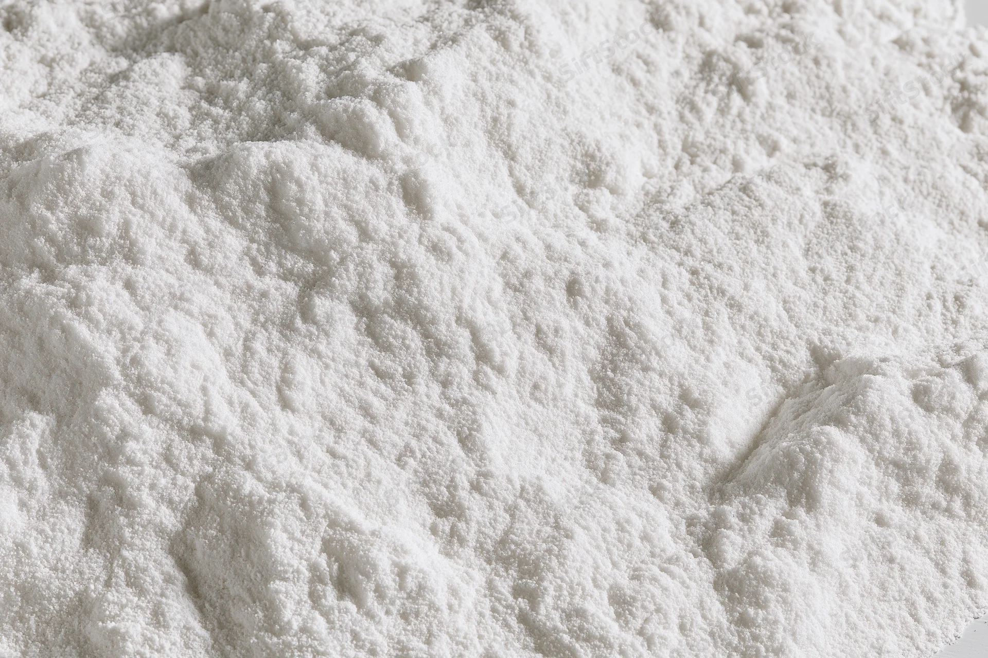 Closeup of white powder heap with fine granular texture