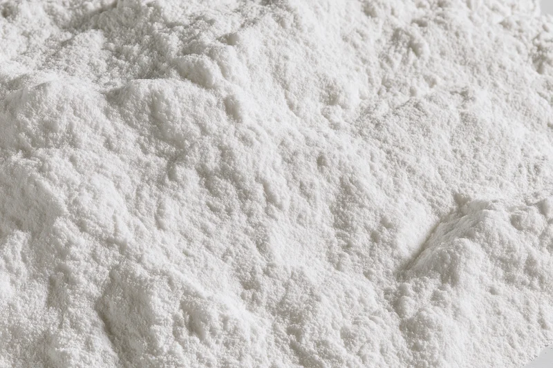 Closeup of white powder heap with fine granular texture