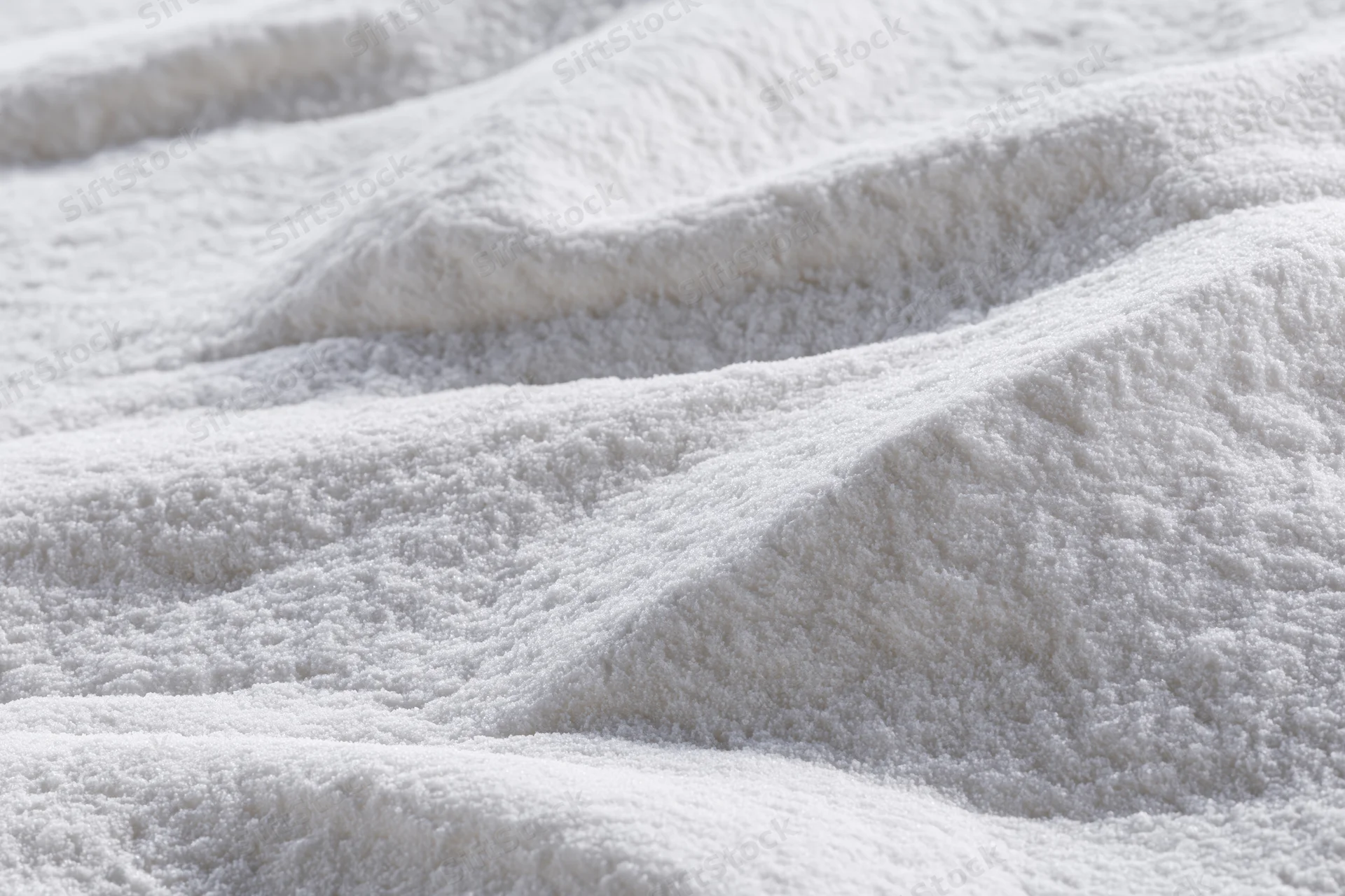 Closeup of white plush towel fabric with soft textured loops and folds