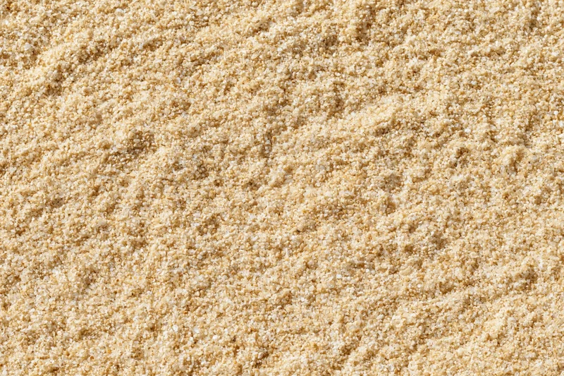Close-up of fine sand texture covering the entire frame