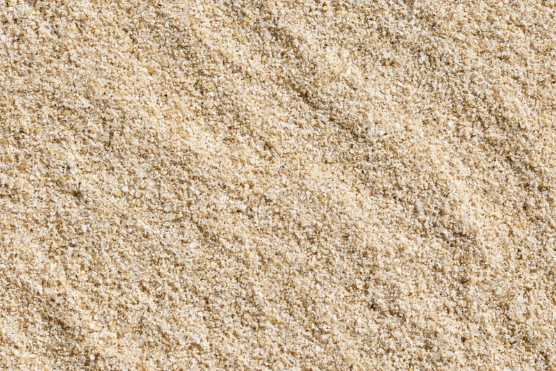 Closeup of fine beige sand texture covering the frame