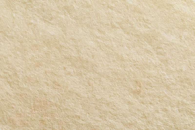 Textured beige paper surface filling the frame