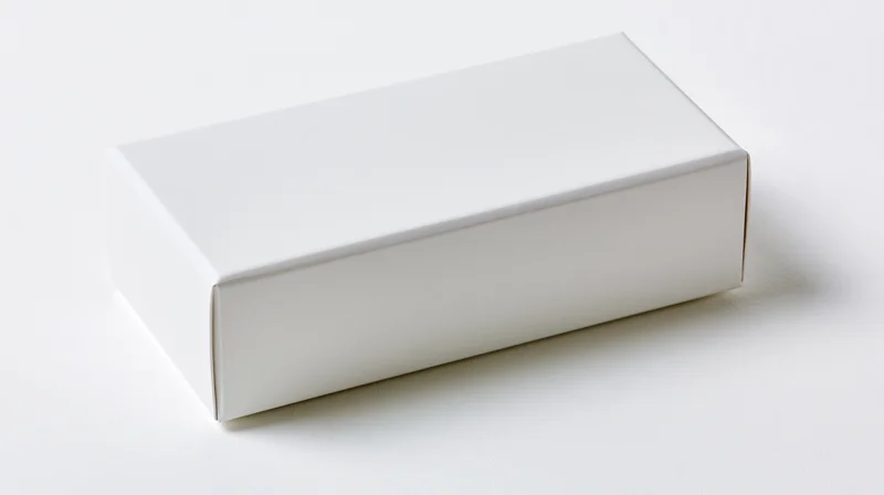 White rectangular box on plain white surface with soft shadow, blank and unbranded for product presentation