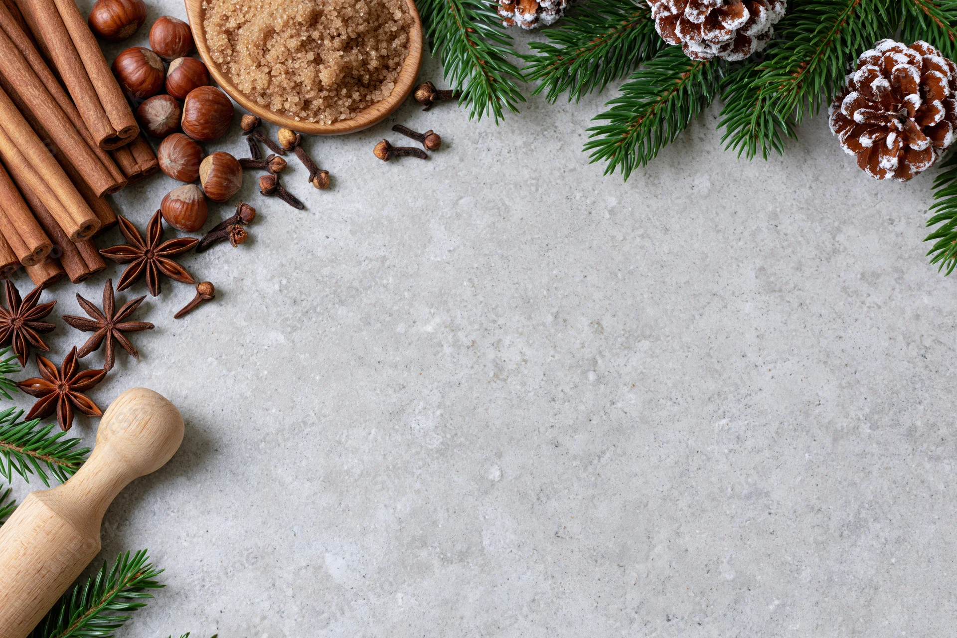 Christmas decorations and spices arranged on a gray countertop with copyspace