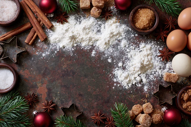 Christmas baking ingredients arranged on rustic tabletop with copyspace