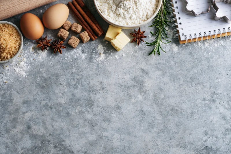 Baking ingredients arranged on a countertop with copyspace for recipe notes