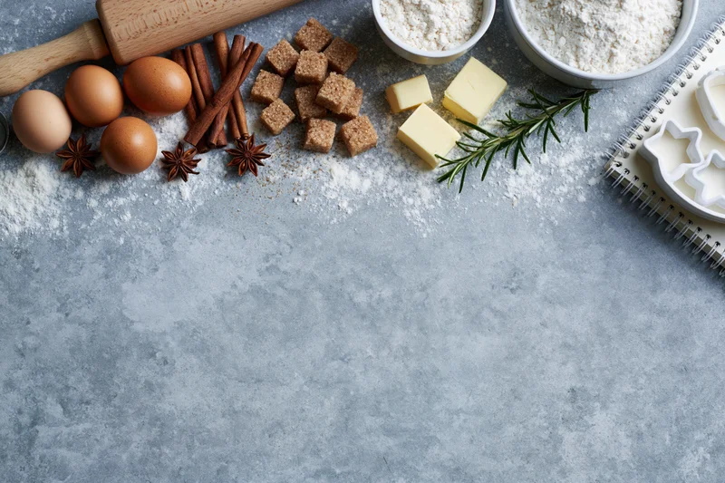 Baking ingredients arranged on a gray countertop with copyspace