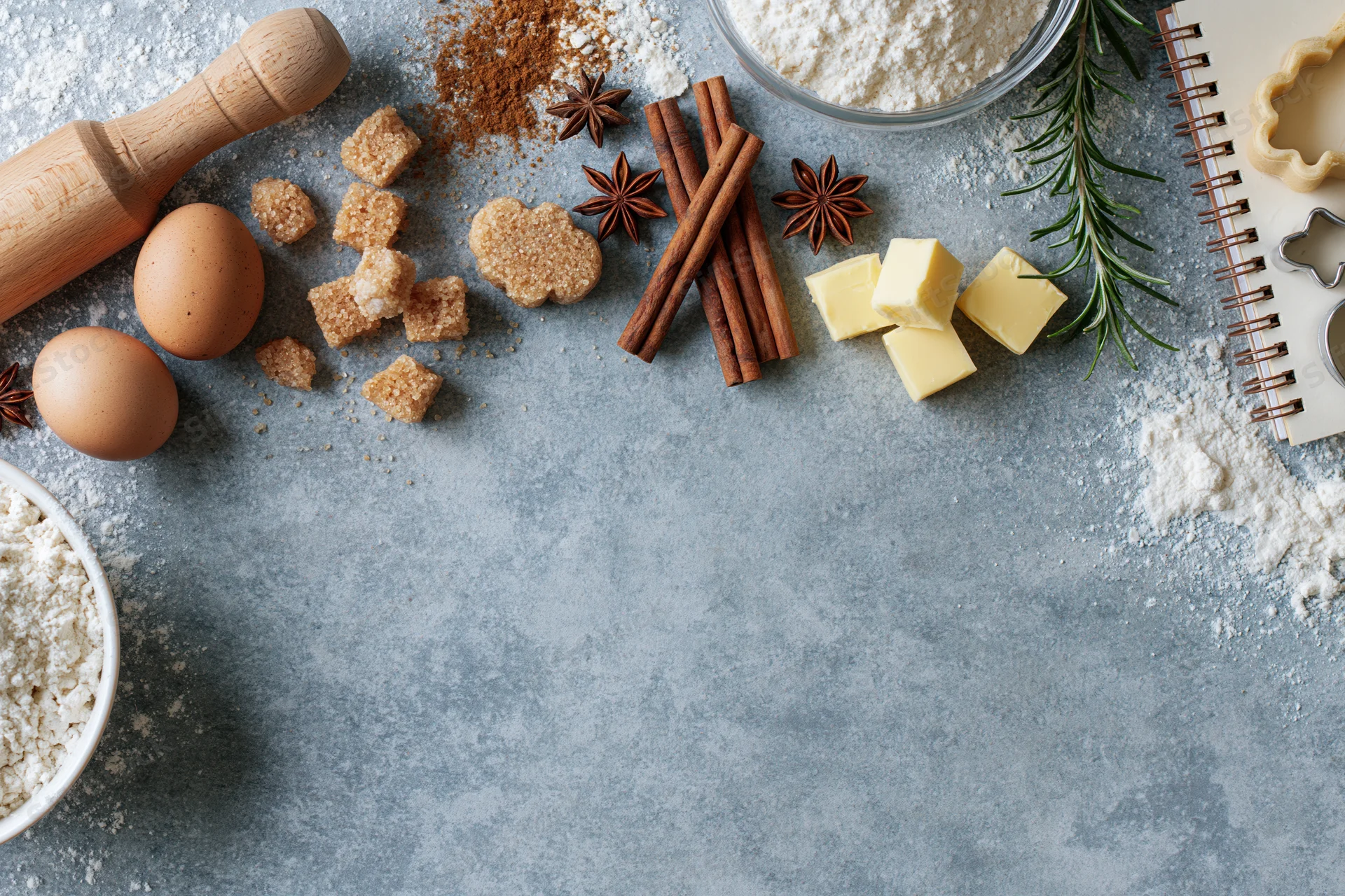 Baking ingredients arranged on a gray countertop with copyspace for recipe text
