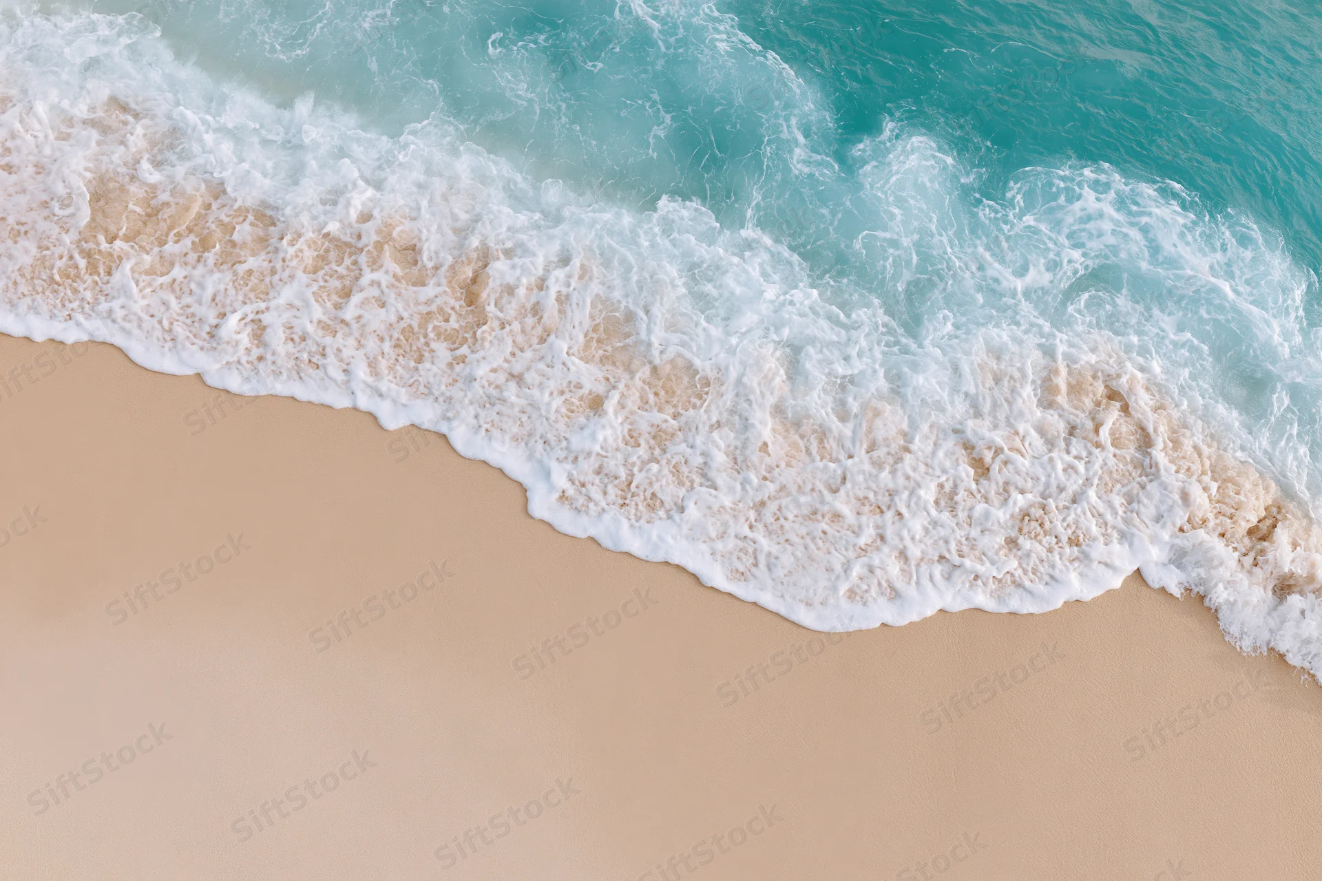 Turquoise ocean wave crashing onto sandy beach