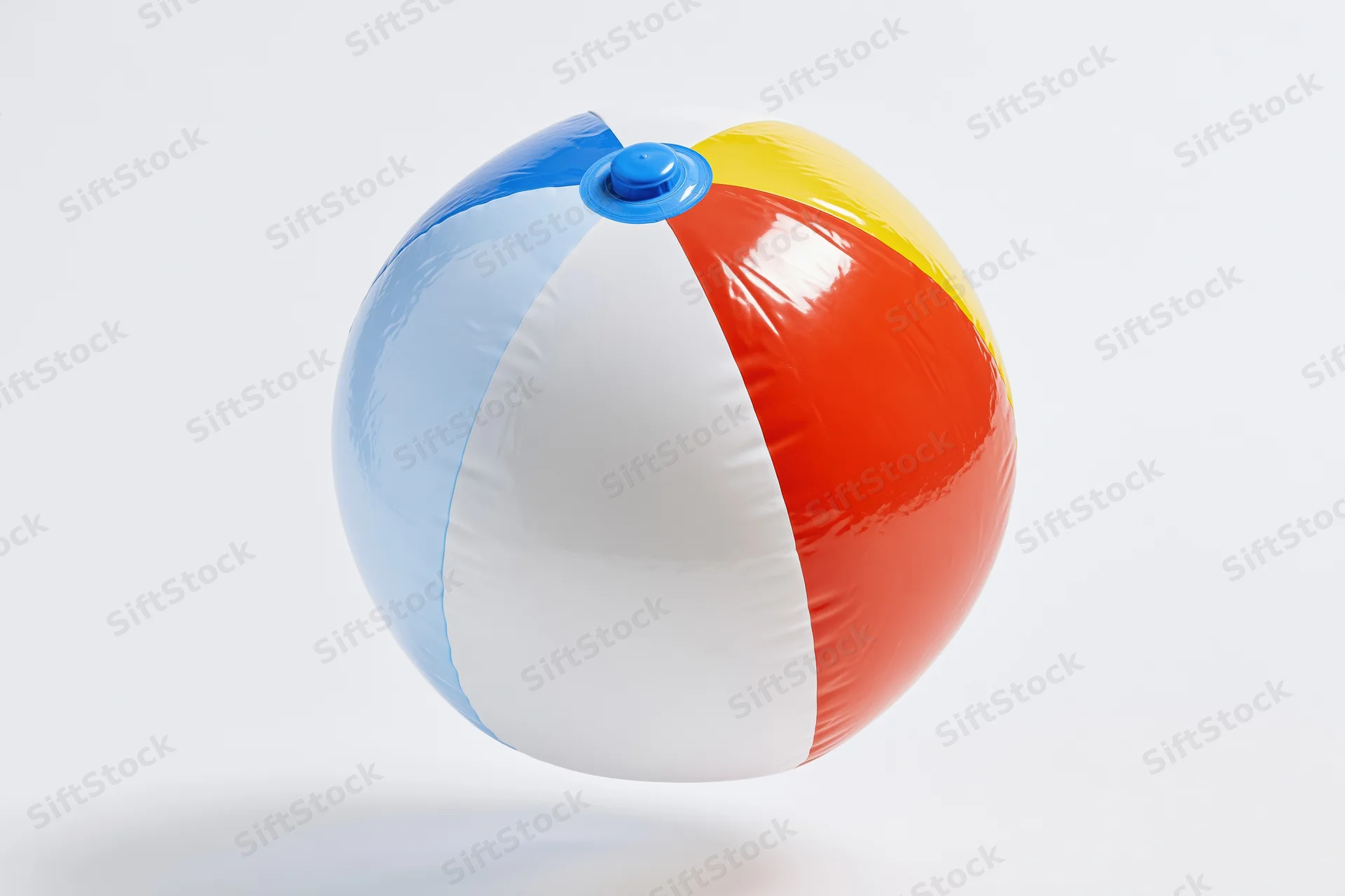 Colorful inflatable beachball floating against white background