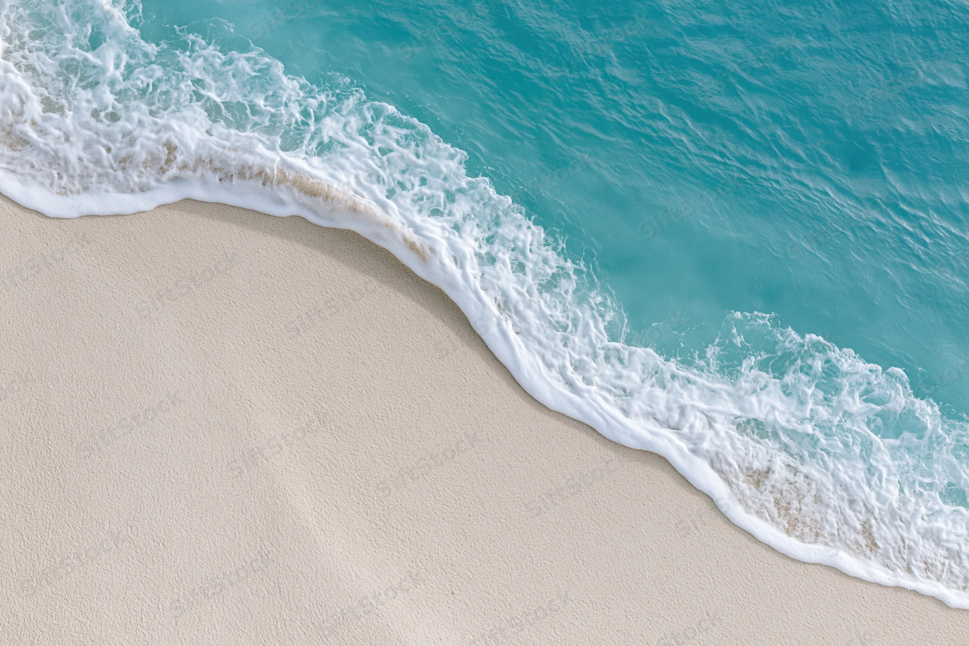 Turquoise ocean wave with white foam washing over sandy beach
