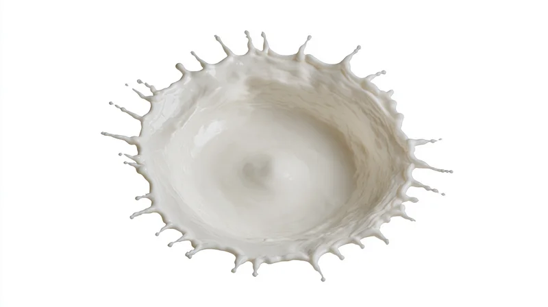 Milk splash captured mid-air against white background
