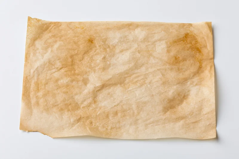 Crumpled brown parchment paper sheet on white background