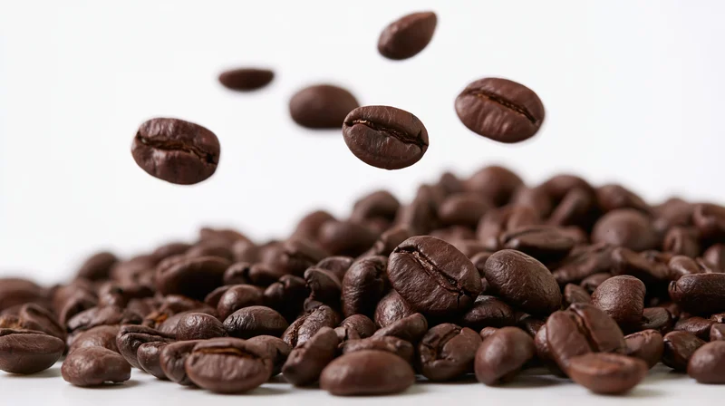 Flying Roasted Coffee Beans in Midair Against a Bright White