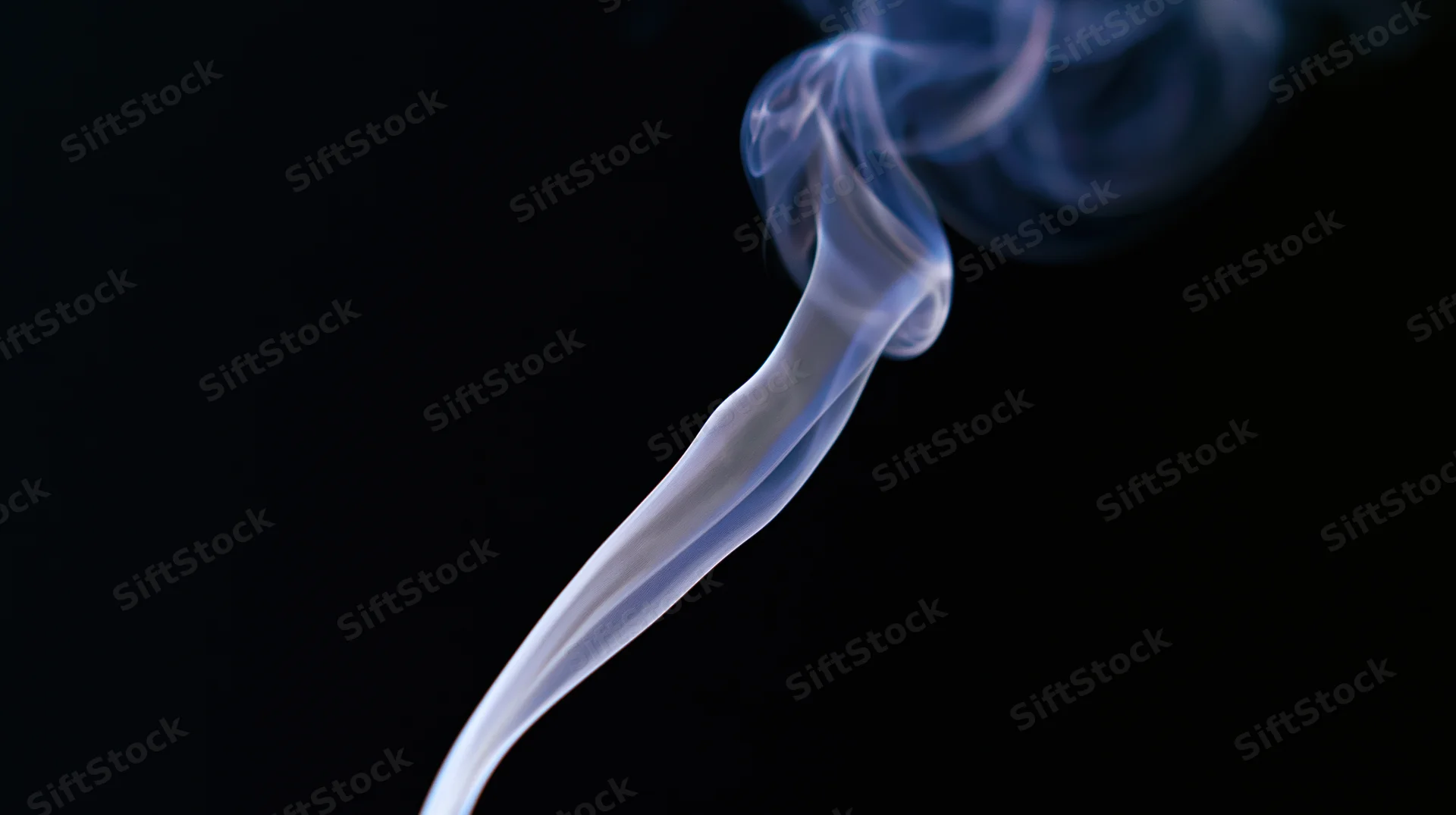 Wispy smoke rising in a dark background