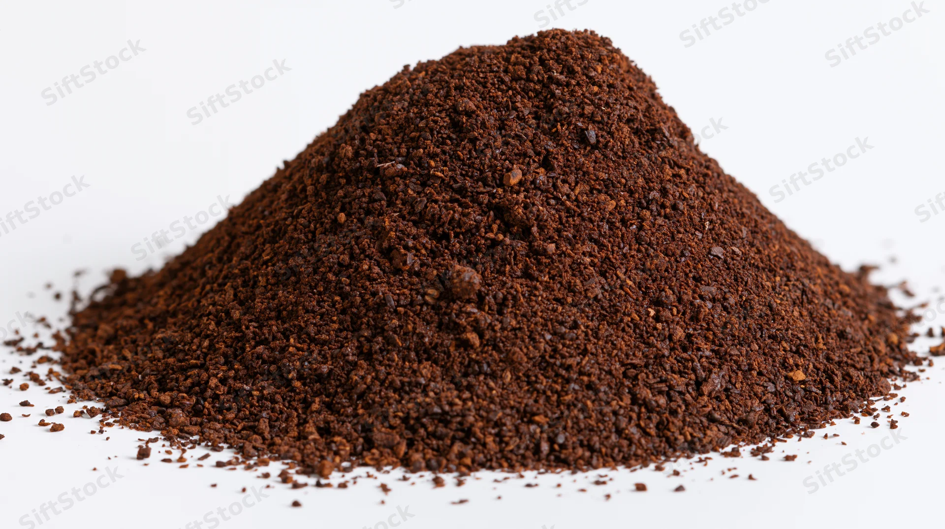 Pile of ground coffee powder on white background