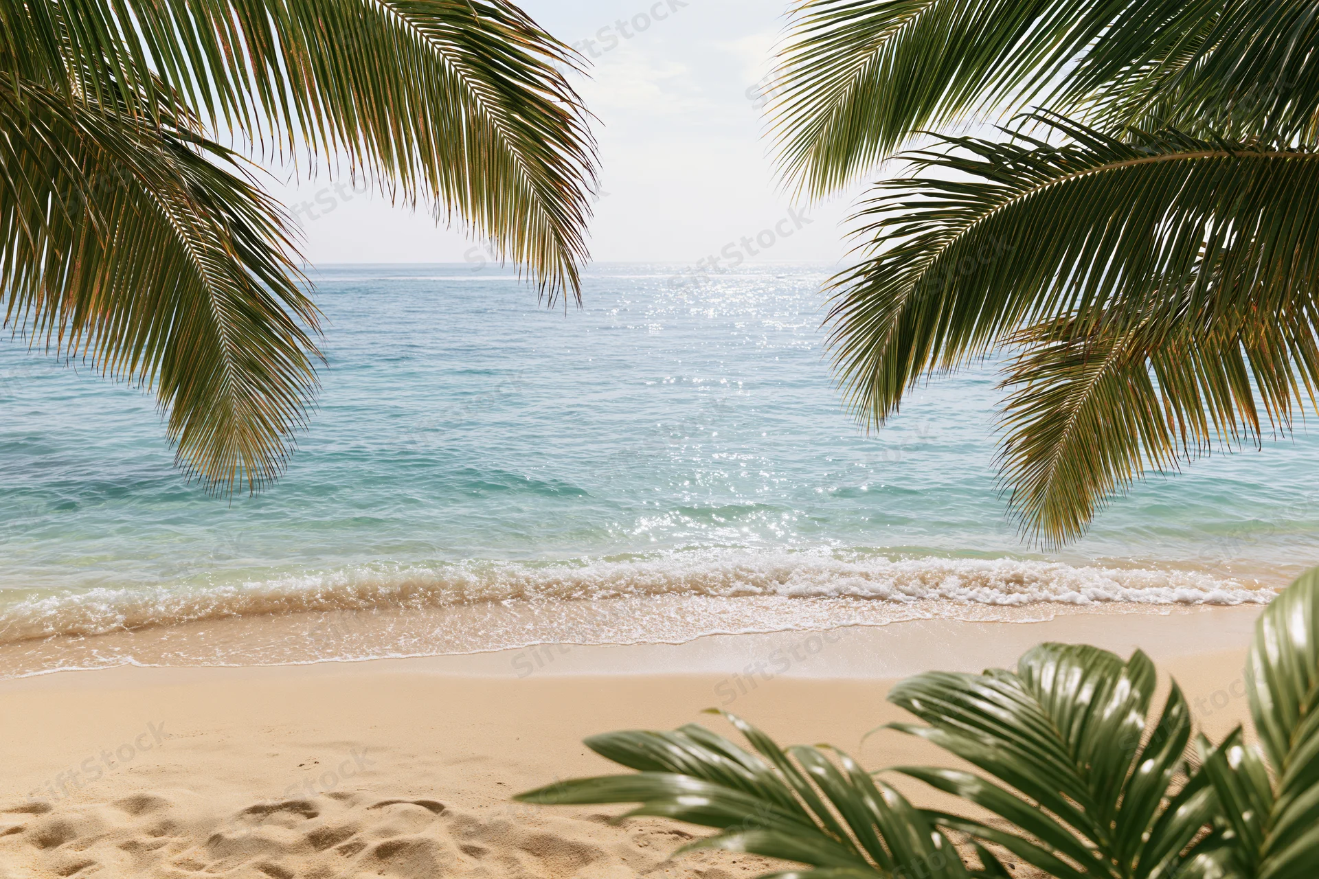 Tropical beach framed by palm fronds with ocean waves and sandy shore