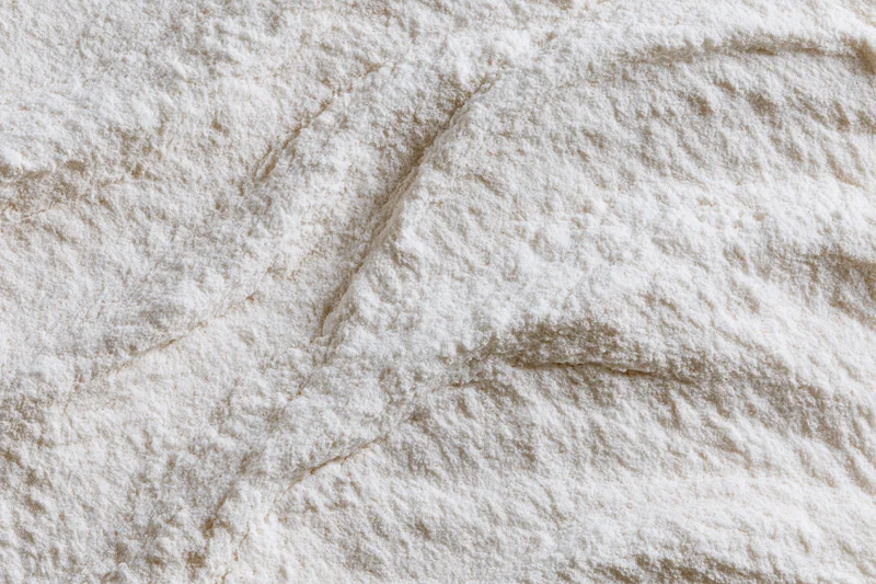 Closeup of white flour powder texture with soft undisturbed surface