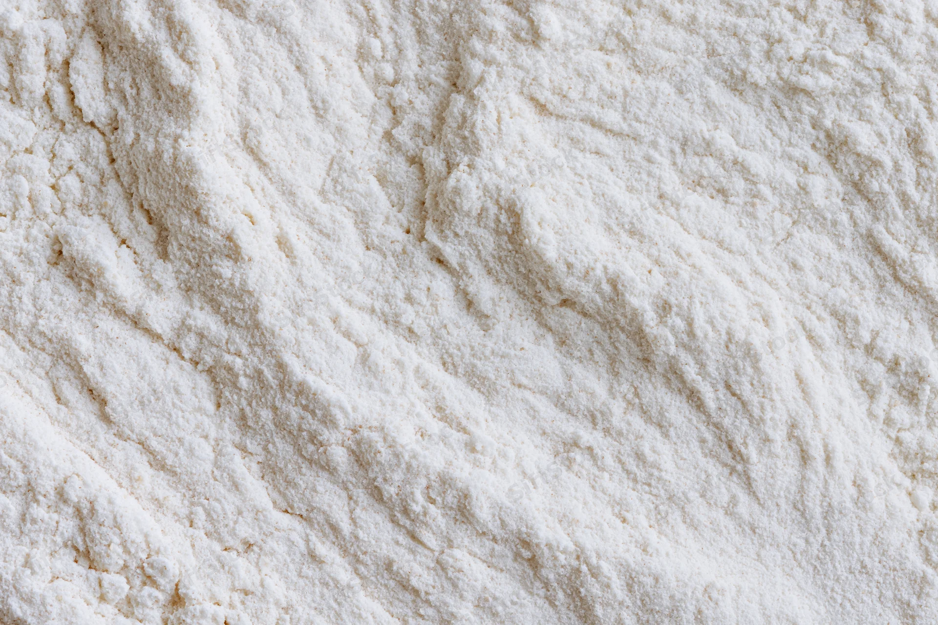 Closeup of white flour pile showing fine powdery texture