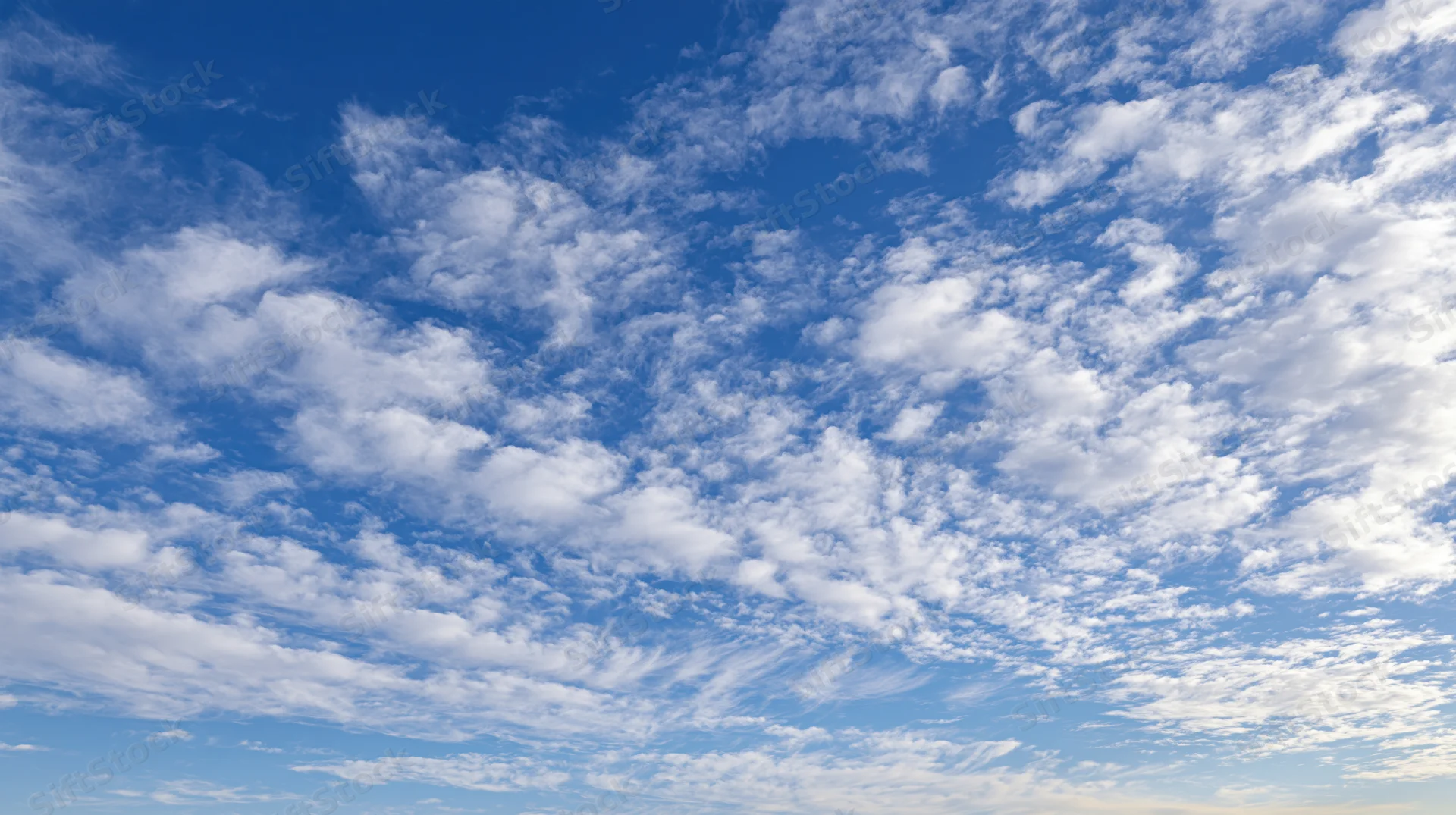 Blue sky filled with scattered white clouds during daytime