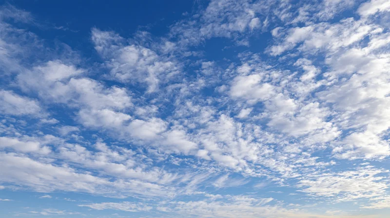 Blue sky filled with scattered white clouds during daytime