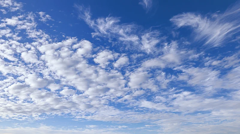 Blue sky filled with white cumulus and cirrus clouds during daytime