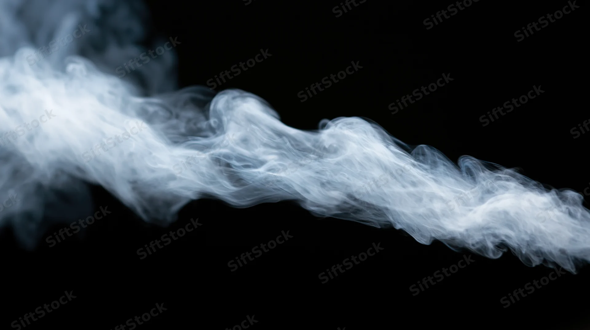 White smoke swirling across a black background