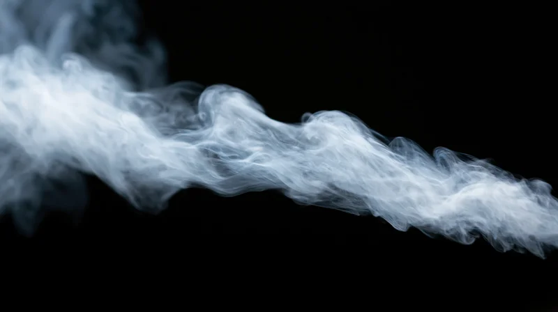 White smoke swirling across a black background