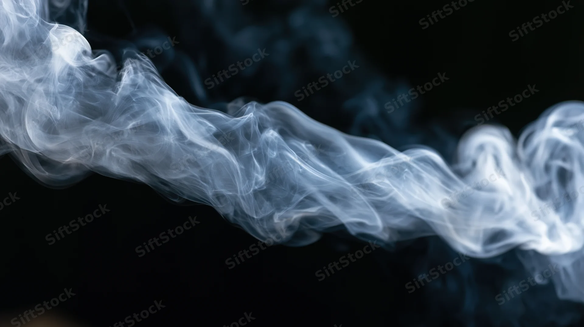 Swirling white smoke against a dark background