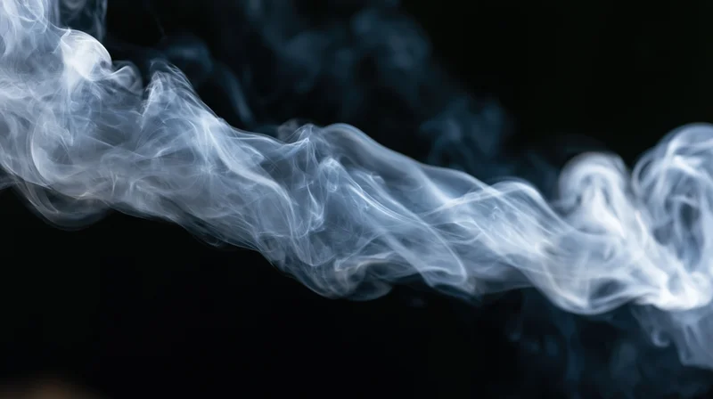 Swirling white smoke against a dark background