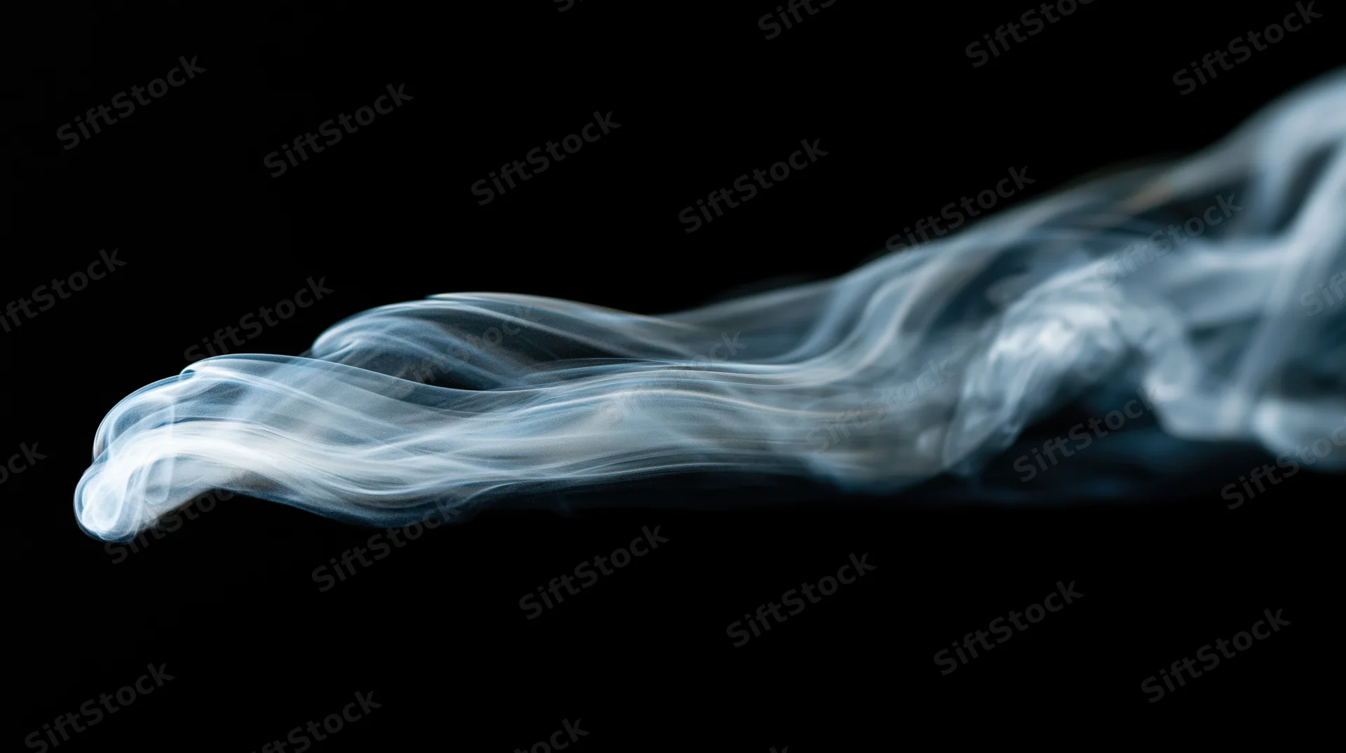 Swirling white smoke plume against black background