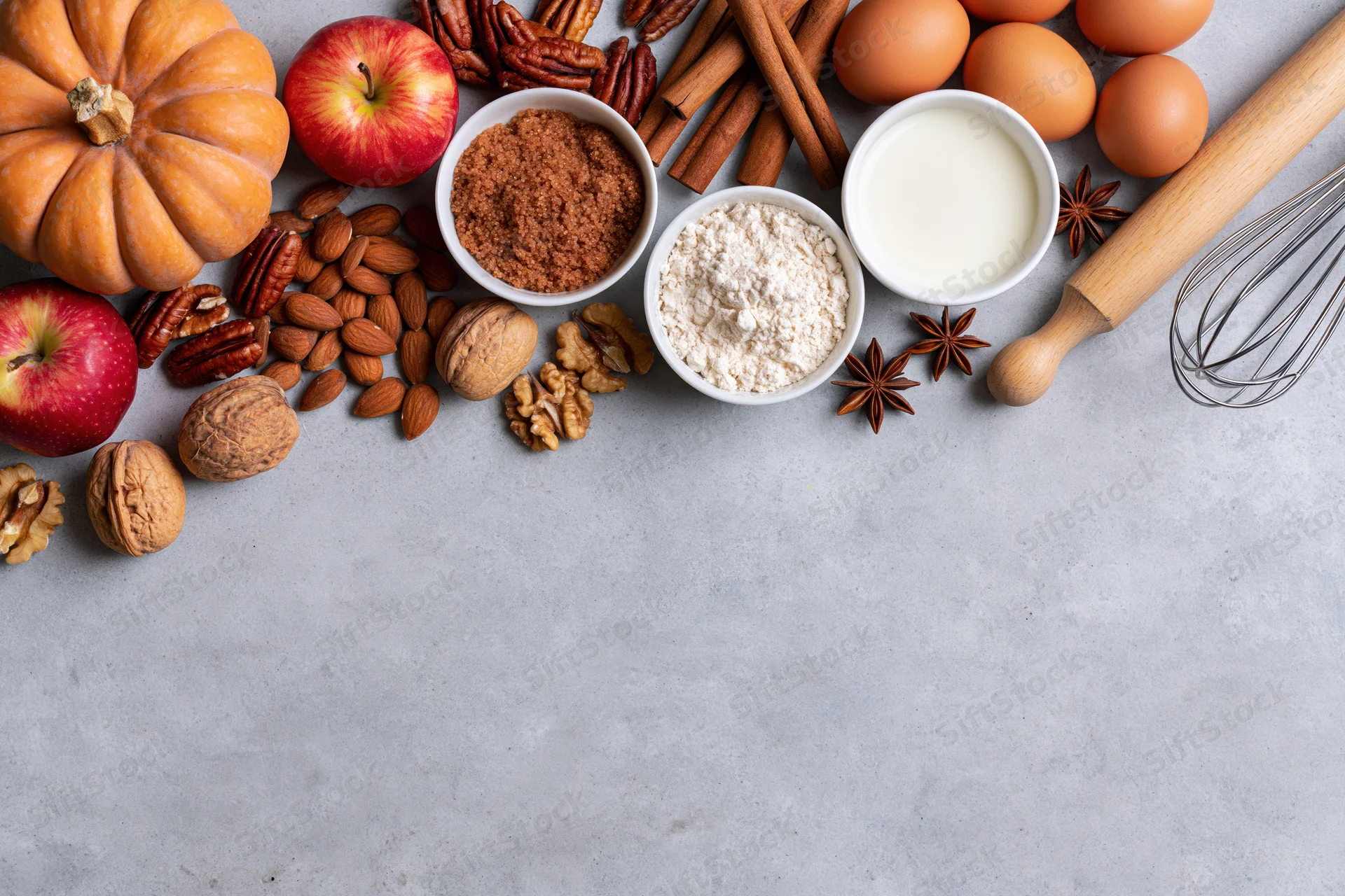 Baking ingredients arranged on a gray countertop with copyspace