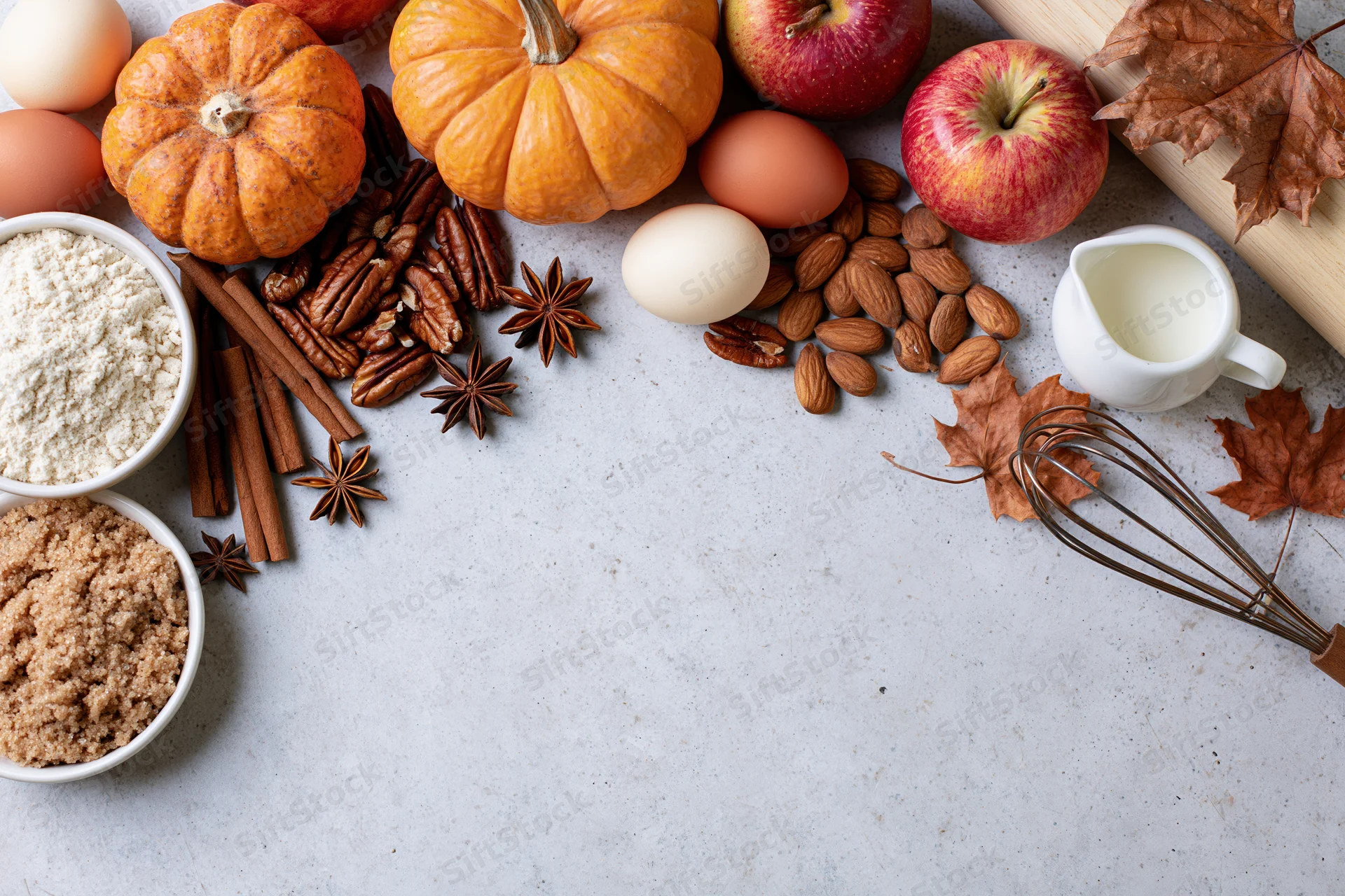 Autumn baking ingredients arranged on a countertop with copyspace