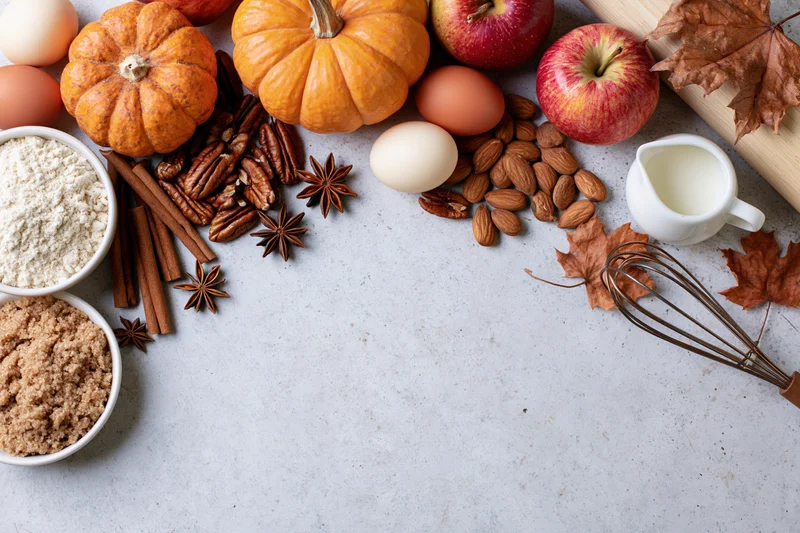 Autumn baking ingredients arranged on a countertop with copyspace