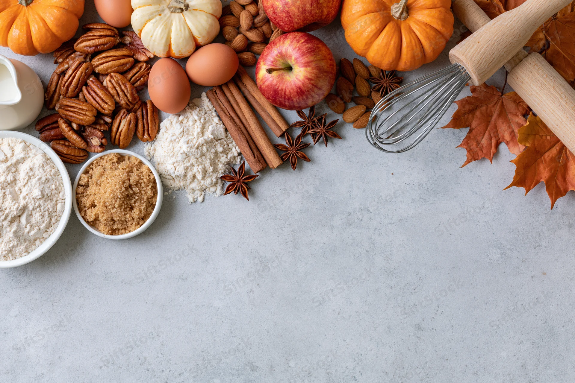 Autumn baking ingredients arranged on a countertop with copyspace