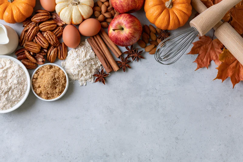 Autumn baking ingredients arranged on a countertop with copyspace