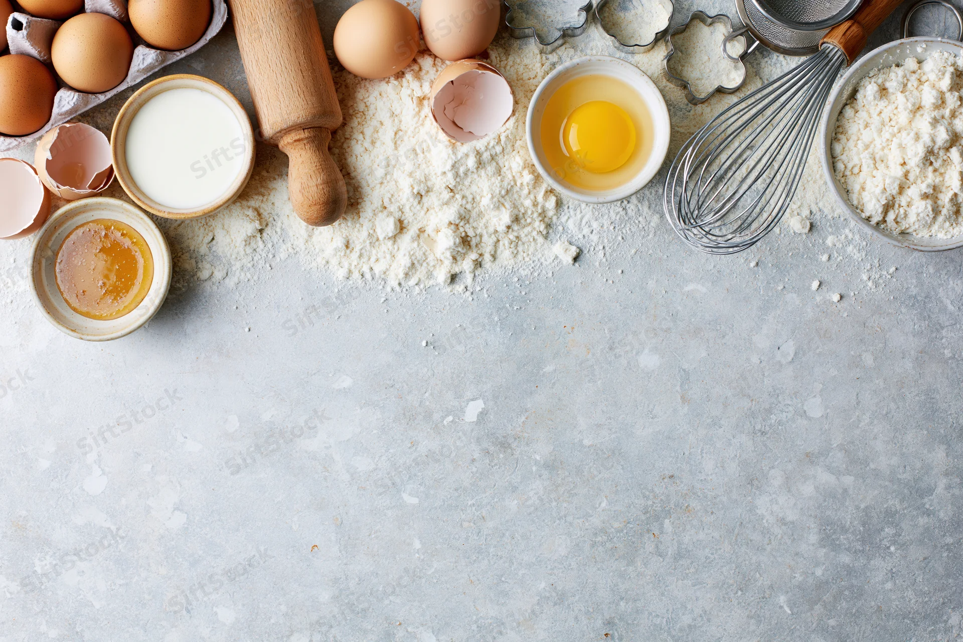 Baking ingredients arranged on a countertop with copyspace below