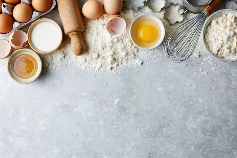 Baking ingredients arranged on a countertop with copyspace below