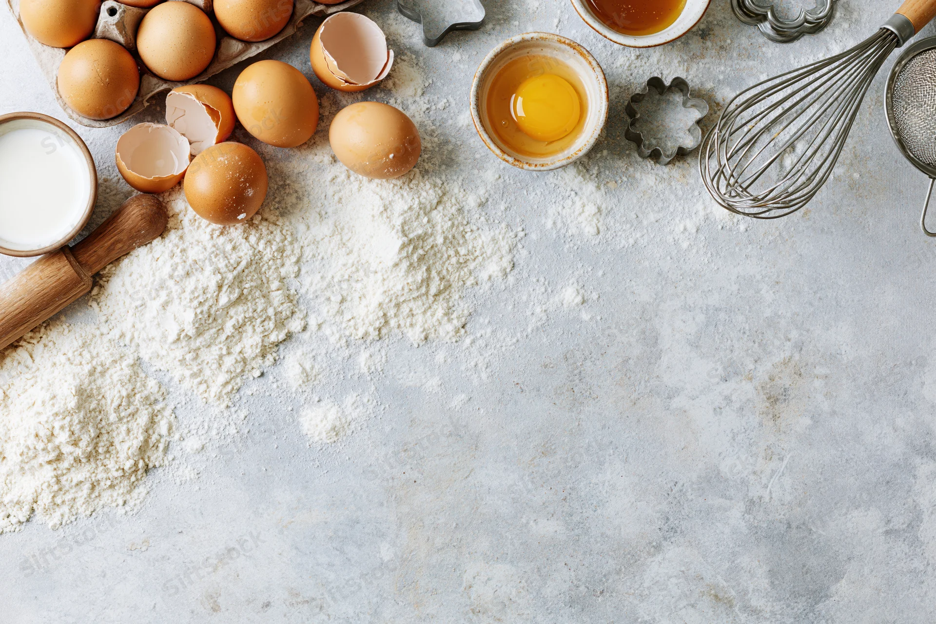 Baking ingredients and tools arranged on a countertop with copyspace