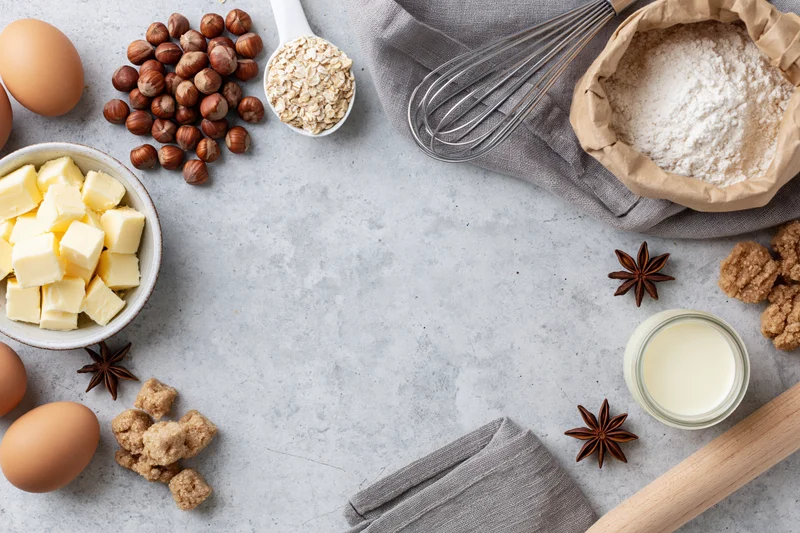 Baking ingredients arranged on a gray countertop with copyspace