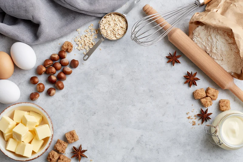 Baking ingredients arranged on a gray countertop in a flat lay overhead view