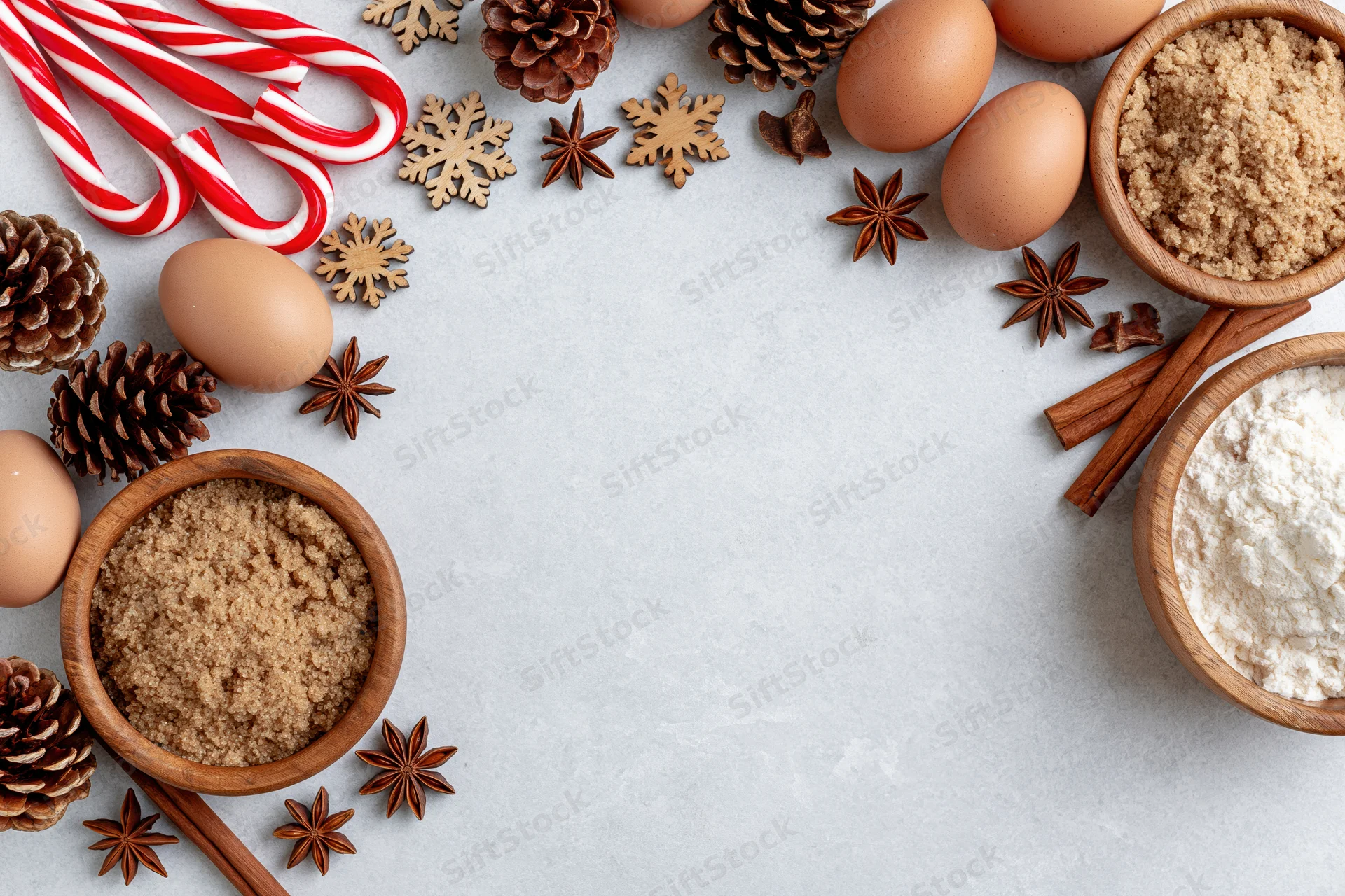 Christmas baking ingredients arranged around the edges of a countertop with copyspace in the center
