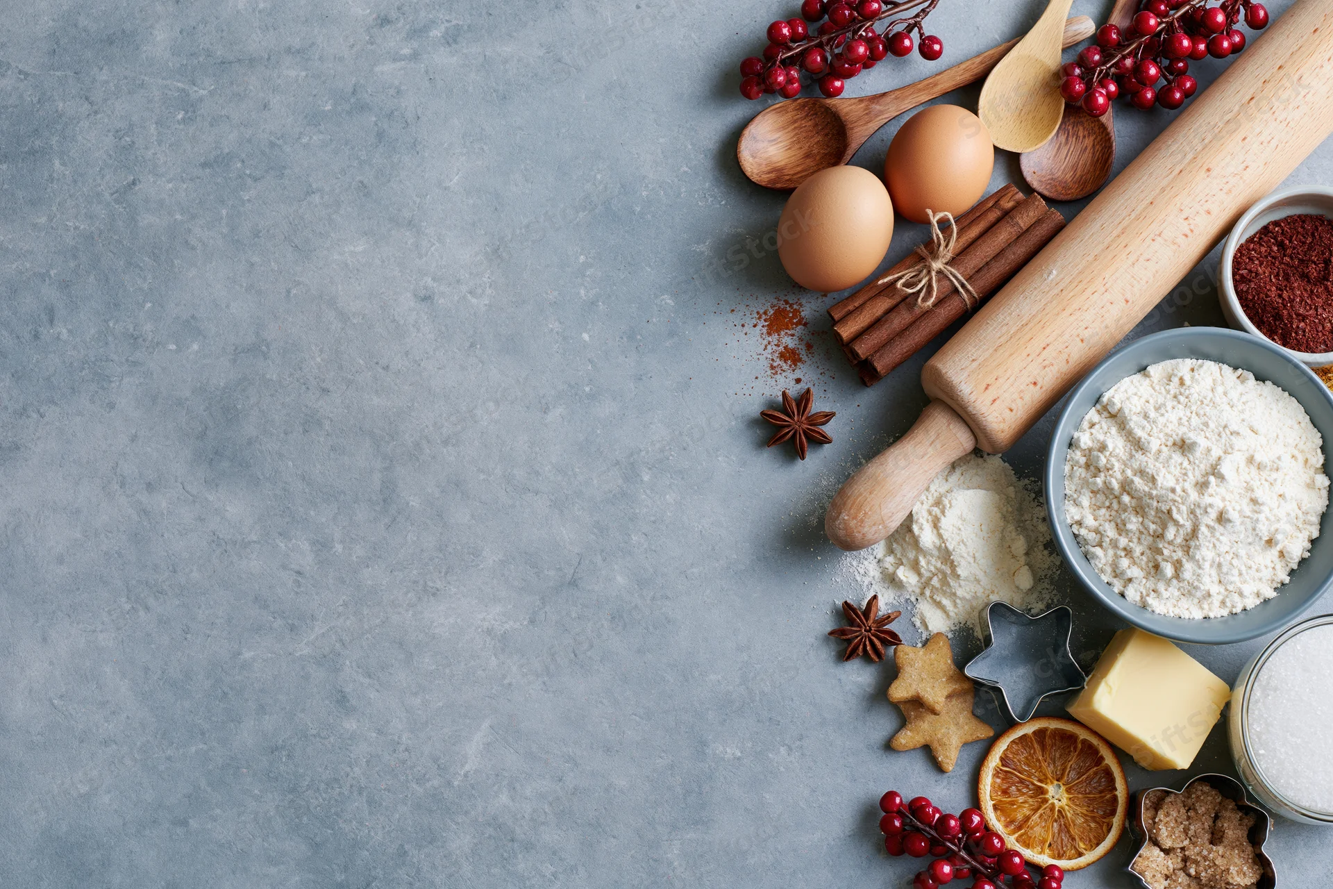 Baking ingredients arranged on a gray countertop with copyspace