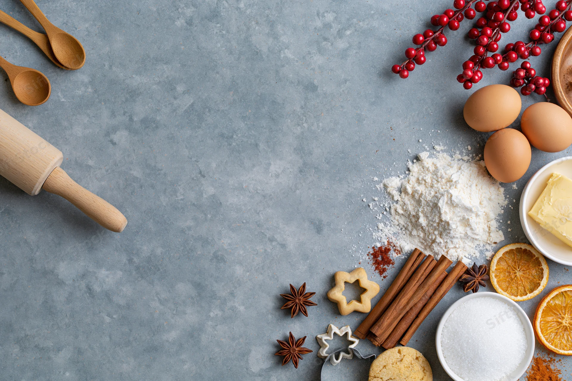 Baking ingredients arranged on a gray countertop with copyspace for holiday recipe presentation