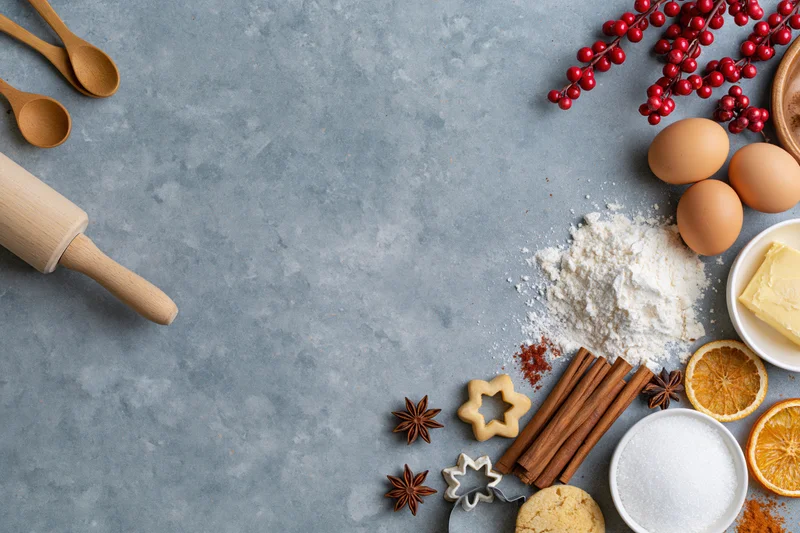 Baking ingredients arranged on a gray countertop with copyspace for holiday recipe presentation